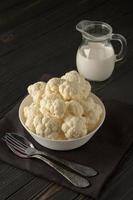 Raw, fresh organic cauliflower on a wooden background. Healthy eating, low carb diet concept photo