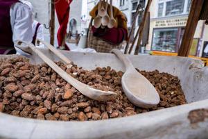 Close-up of roasted almonds in container for sale at market in historic town photo