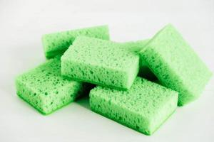 Green sponges for cleaning on a white background photo