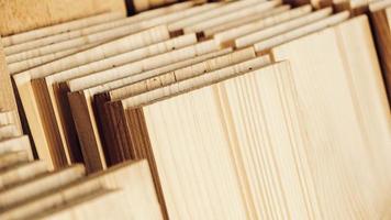 Stacked wooden carpentry boards from natural wood in a woodworking industry photo