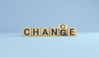 Change for chance concept. Wooden cube block flip over word change to chance on blue studio background. photo