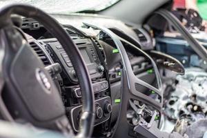 Close-up of the steering wheel of a car after an accident. The driver's airbags did not deploy. Soft focus. Broken windshield with steering wheel. Vehicle interior. Ukraine, Irpen - May 12, 2022. photo