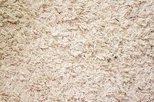 Beige background texture of towel or home carpet. Top view, flat lay. Textile texture of carpet. White or cream pile carpet. Stylish carpet on the floor in the room. Interior Design. photo