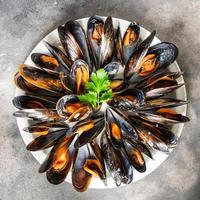 fresh mussels in shells seafood meal on the table copy space food background rustic photo