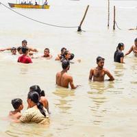 Garh Mukteshwar, Uttar Pradesh, India - June 11 2022 - People are taking holy dip on the occasion of Nirjala Ekadashi, A view of Garh Ganga ghat which is very famous religious place for Hindus photo