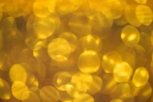 Golden glitter bokeh lighting texture Blurred abstract background for birthday, anniversary, wedding, new year eve or Christmas photo