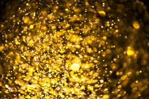 Golden glitter bokeh lighting texture Blurred abstract background for birthday, anniversary, wedding, new year eve or Christmas photo