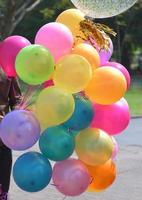 Colorful balloons with celebration and various party confetti photo