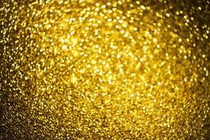 Golden glitter bokeh lighting texture Blurred abstract background for birthday, anniversary, wedding, new year eve or Christmas photo