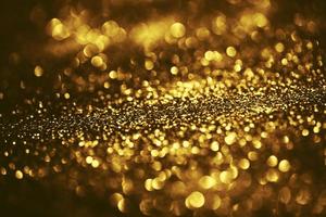 Golden glitter bokeh lighting texture Blurred abstract background for birthday, anniversary, wedding, new year eve or Christmas photo