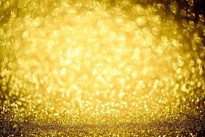 Golden glitter bokeh lighting texture Blurred abstract background for birthday, anniversary, wedding, new year eve or Christmas photo