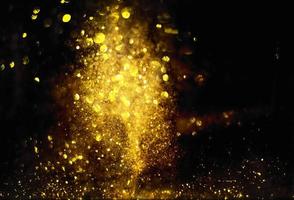 Golden glitter bokeh lighting texture Blurred abstract background for birthday, anniversary, wedding, new year eve or Christmas photo