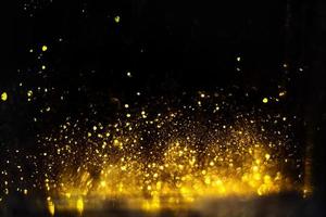 Golden glitter bokeh lighting texture Blurred abstract background for birthday, anniversary, wedding, new year eve or Christmas photo