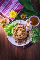 Fluffy spicy catfish with mango sauce Dish dishes on wooden floor Yum Pla-duke Fu photo