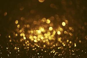 Golden glitter bokeh lighting texture Blurred abstract background for birthday, anniversary, wedding, new year eve or Christmas photo