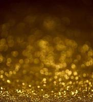 Golden glitter bokeh lighting texture Blurred abstract background for birthday, anniversary, wedding, new year eve or Christmas photo