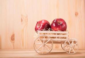 apple red on farm wagon with wood floor background photo