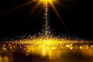 Golden glitter spatter are bokeh lighting texture blurred abstract background for anniversary celebration photo