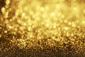 Golden glitter bokeh lighting texture Blurred abstract background for birthday, anniversary, wedding, new year eve or Christmas photo