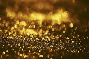 Golden glitter bokeh lighting texture Blurred abstract background for birthday, anniversary, wedding, new year eve or Christmas photo