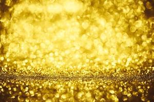 Golden glitter bokeh lighting texture Blurred abstract background for birthday, anniversary, wedding, new year eve or Christmas photo