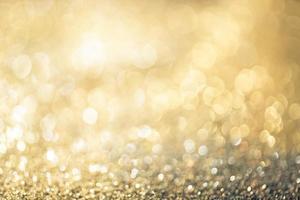 Golden glitter bokeh lighting texture Blurred abstract background for birthday, anniversary, wedding, new year eve or Christmas photo