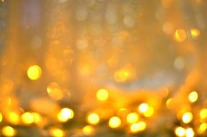 Golden glitter bokeh lighting texture Blurred abstract background for birthday, anniversary, wedding, new year eve or Christmas photo