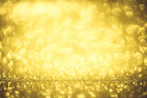 Golden glitter bokeh lighting texture Blurred abstract background for birthday, anniversary, wedding, new year eve or Christmas photo