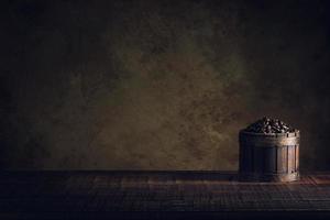 coffee beans in container on wood floor and old paper vintage aged background or texture photo