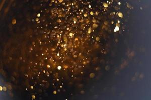 Golden glitter bokeh lighting texture Blurred abstract background for birthday, anniversary, wedding, new year eve or Christmas photo