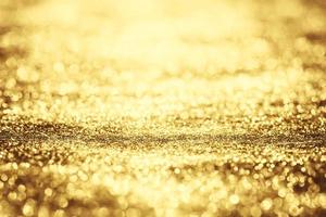 Golden glitter bokeh lighting texture Blurred abstract background for birthday, anniversary, wedding, new year eve or Christmas photo