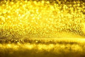 Golden glitter bokeh lighting texture Blurred abstract background for birthday, anniversary, wedding, new year eve or Christmas photo