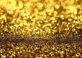 Golden glitter bokeh lighting texture Blurred abstract background for birthday, anniversary, wedding, new year eve or Christmas photo