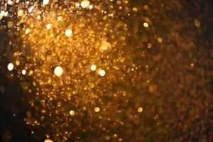 Golden glitter bokeh lighting texture Blurred abstract background for birthday, anniversary, wedding, new year eve or Christmas photo