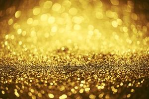 Golden glitter bokeh lighting texture Blurred abstract background for birthday, anniversary, wedding, new year eve or Christmas photo