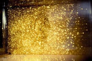 Golden glitter bokeh lighting texture Blurred abstract background for birthday, anniversary, wedding, new year eve or Christmas photo