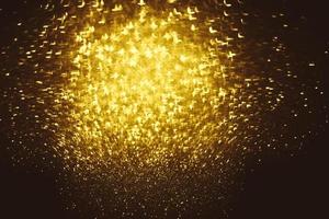 Golden glitter bokeh lighting texture Blurred abstract background for birthday, anniversary, wedding, new year eve or Christmas photo