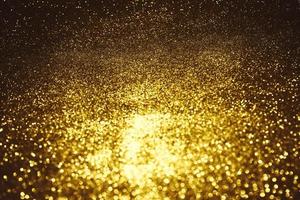 Golden glitter bokeh lighting texture Blurred abstract background for birthday, anniversary, wedding, new year eve or Christmas photo