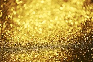 Golden glitter bokeh lighting texture Blurred abstract background for birthday, anniversary, wedding, new year eve or Christmas photo