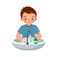 Cute Young boy washing hands with antibacterial soap and running water under faucet at the sink as prevention against Virus and Infection and personal hygiene