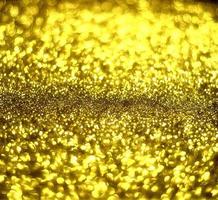 Golden glitter bokeh lighting texture Blurred abstract background for birthday, anniversary, wedding, new year eve or Christmas photo