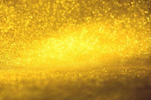 Golden glitter bokeh lighting texture Blurred abstract background for birthday, anniversary, wedding, new year eve or Christmas photo