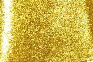 Golden glitter bokeh lighting texture Blurred abstract background for birthday, anniversary, wedding, new year eve or Christmas photo