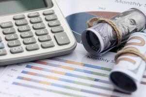 Data analysis with isolated bank notes and calculator. Business finance concept photo