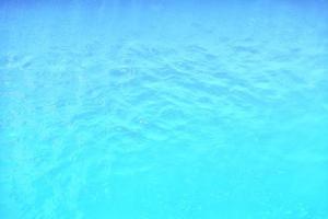 Waving water surface background in the pool. photo