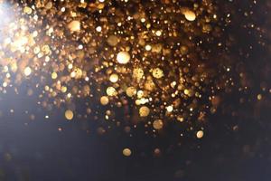 Golden glitter bokeh lighting texture Blurred abstract background for birthday, anniversary, wedding, new year eve or Christmas photo