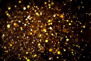 Golden glitter bokeh lighting texture Blurred abstract background for birthday, anniversary, wedding, new year eve or Christmas photo