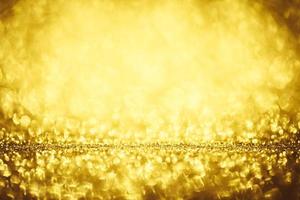 Golden glitter bokeh lighting texture Blurred abstract background for birthday, anniversary, wedding, new year eve or Christmas photo