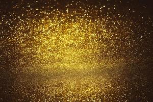 Golden glitter bokeh lighting texture Blurred abstract background for birthday, anniversary, wedding, new year eve or Christmas photo