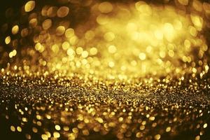 Golden glitter bokeh lighting texture Blurred abstract background for birthday, anniversary, wedding, new year eve or Christmas photo